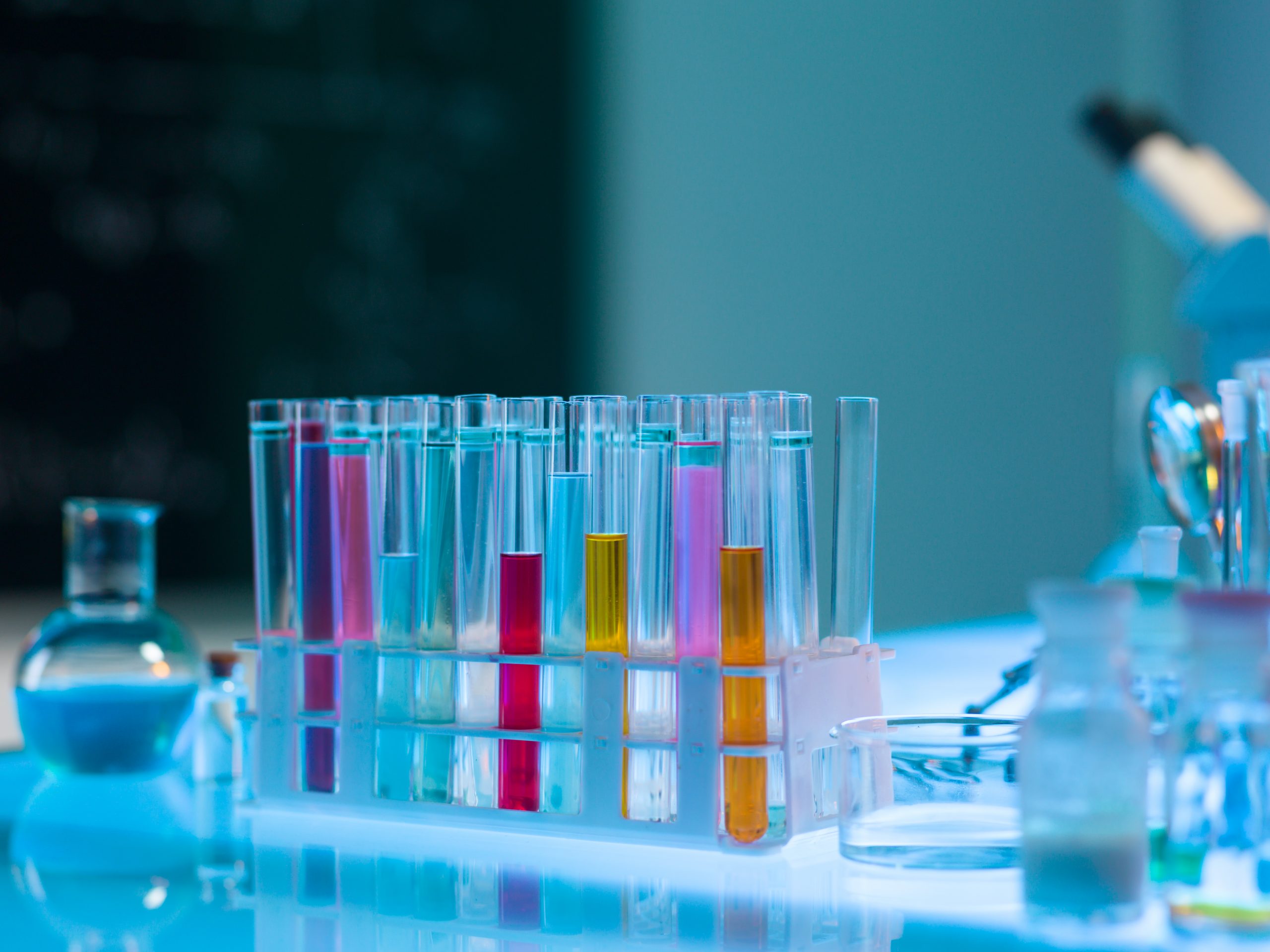 close-up of colorful medical tubes placed in a plastic rack, in a laboratory